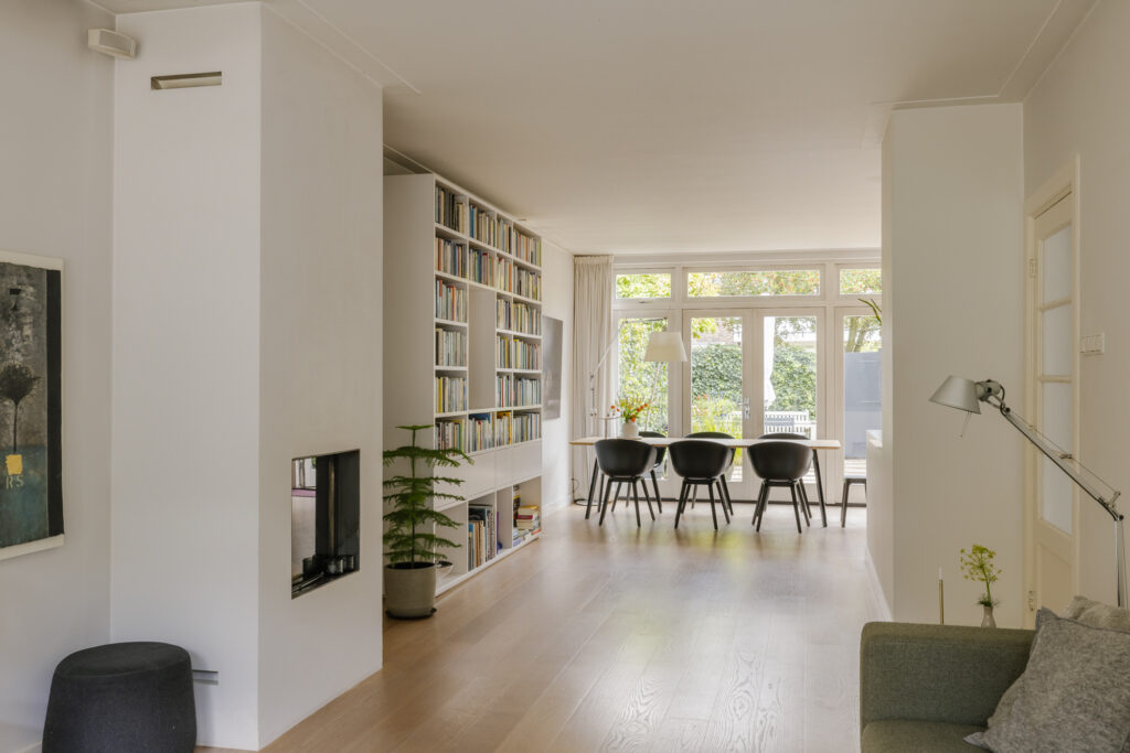 Modern living room with bookshelf and dining area