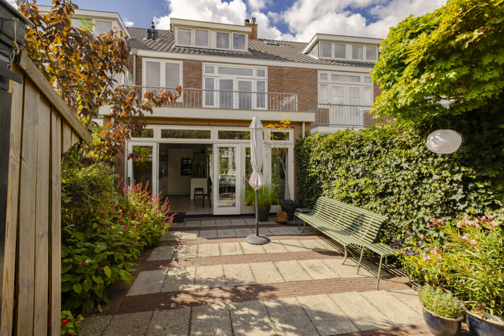 Sunny backyard with modern glass door entrance.