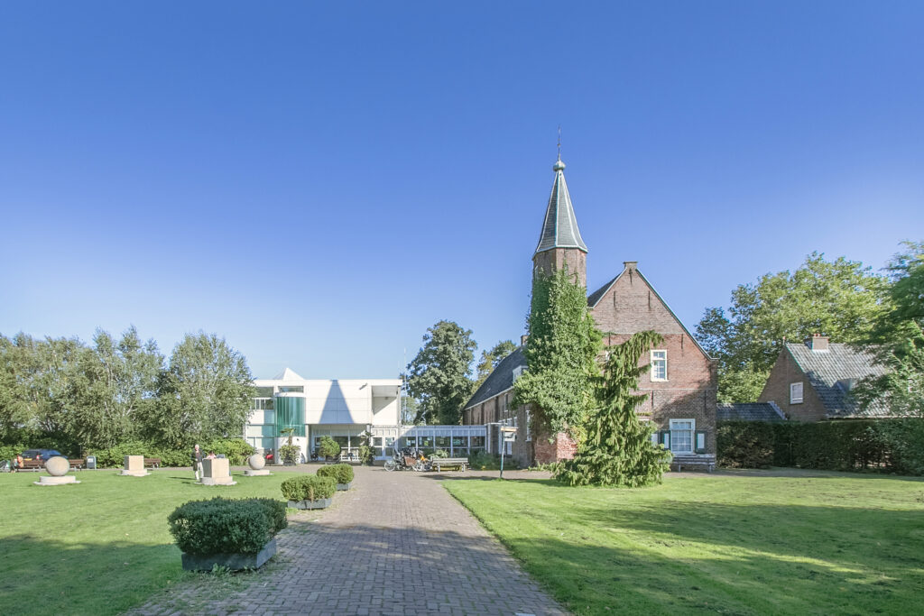 Brick building with tower on sunny day.