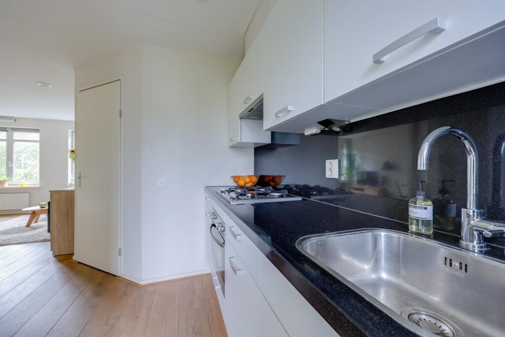Modern kitchen with black countertop and sink