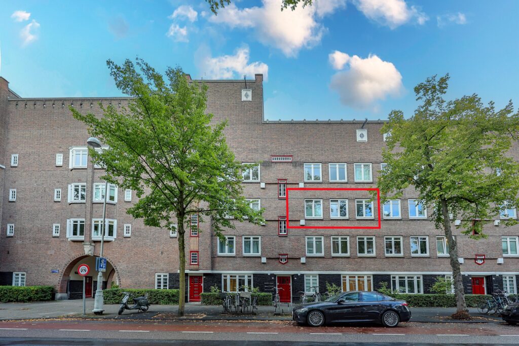 Brick building with highlighted window section.