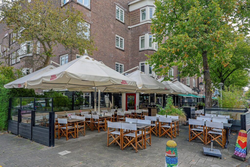 Outdoor cafe with empty tables and chairs