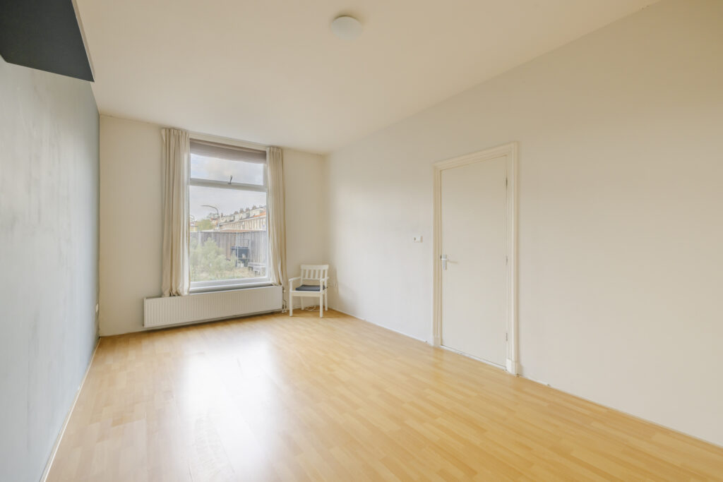 Empty room with large window and chair
