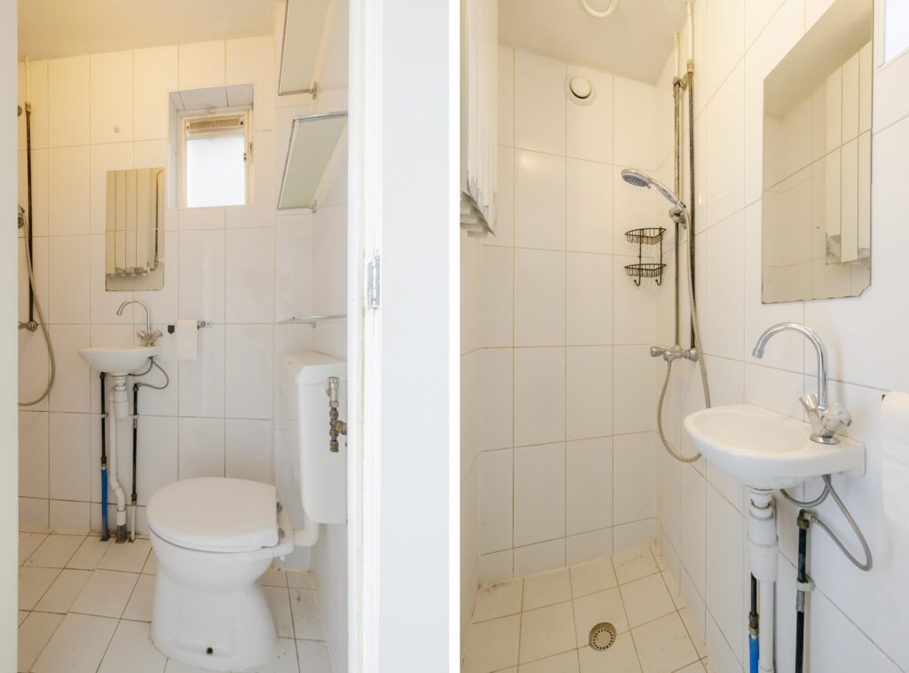 Small bathroom with shower, toilet, and sink.