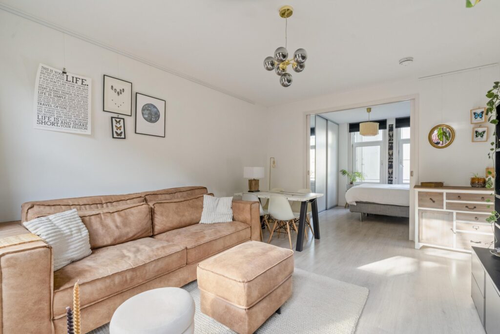 Modern living room with beige couch and decorations
