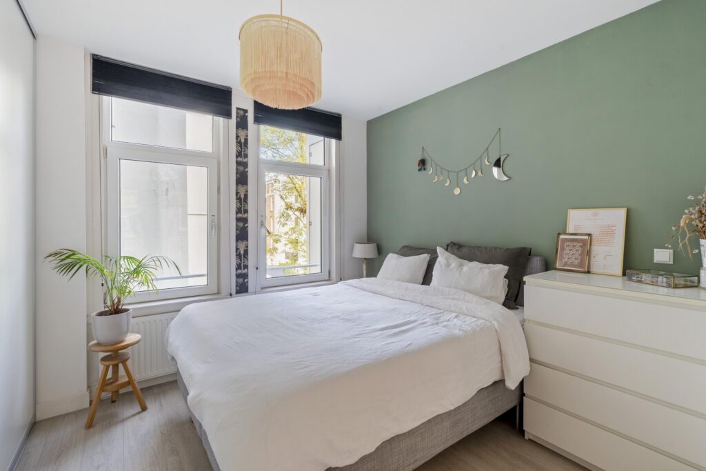 Modern bedroom with green accent wall