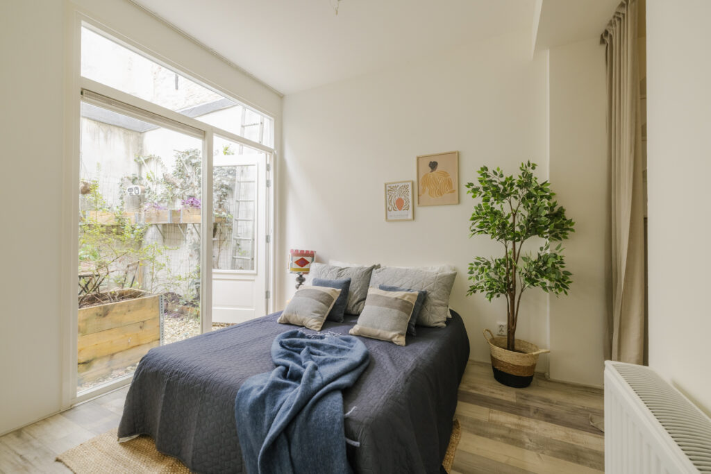 Cozy bedroom with garden view and modern decor.
