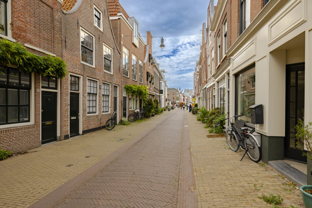 Charming European street with brick buildings, bicycles, pedestrians.