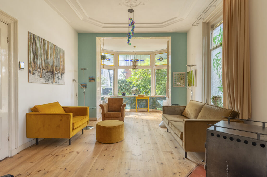 Bright living room with colorful furniture and stained glass.