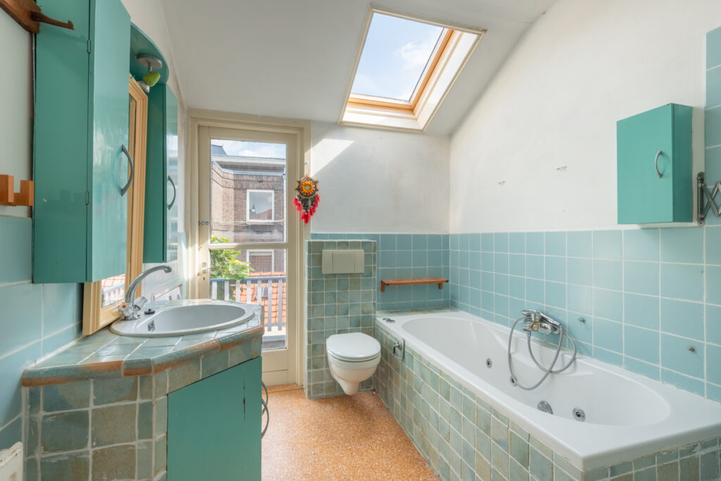 Sunny bathroom with skylight and blue tiles