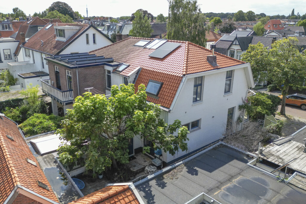 Aerial view of houses with red tiled roofs.