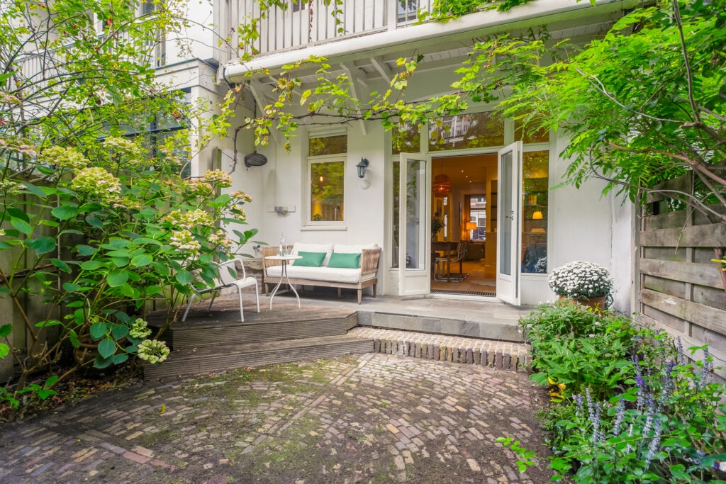 Cozy patio garden with open glass doors