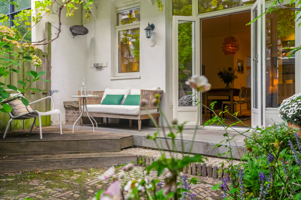 Cozy backyard patio with open doors to home.
