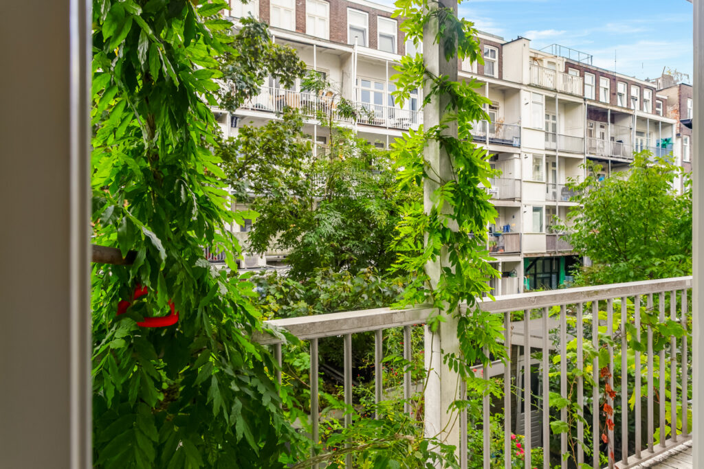Lush greenery outside city apartment balcony view