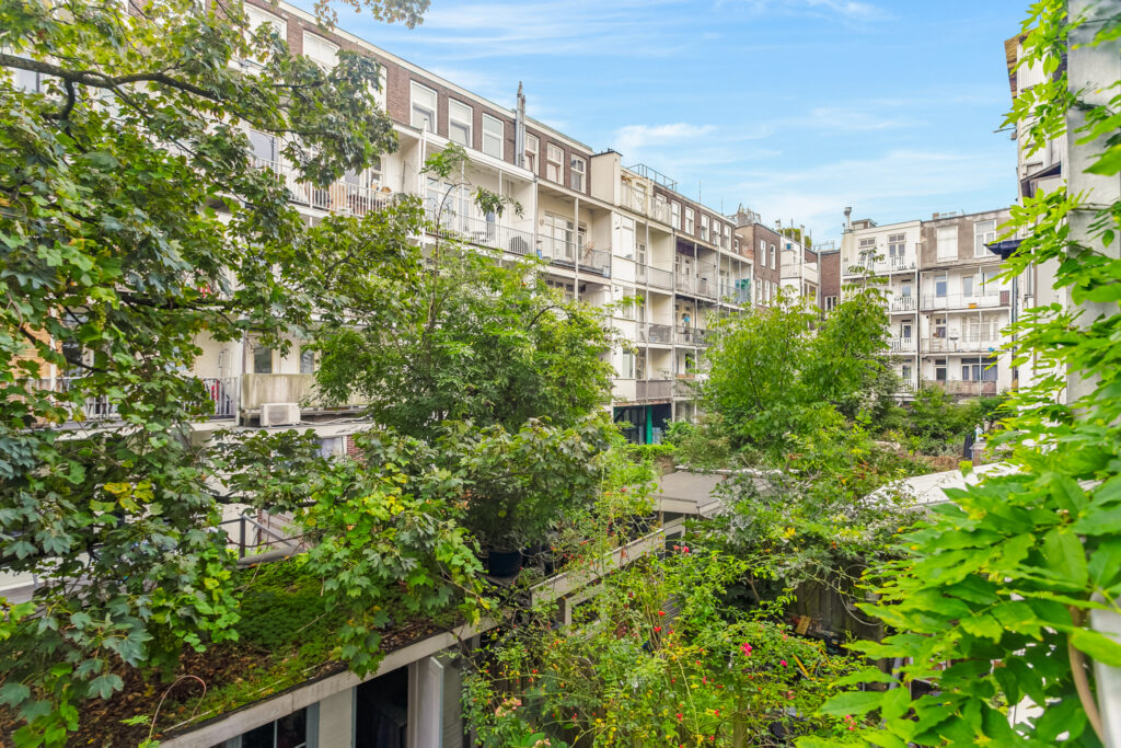 Urban residential buildings with lush green surroundings.