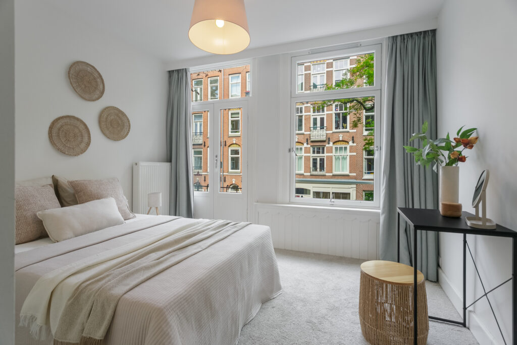 Modern bedroom with bed and large windows
