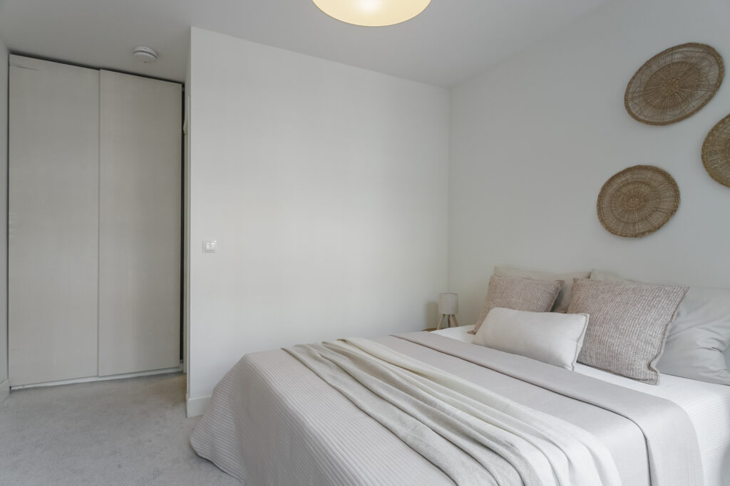 Modern, minimalist bedroom with neutral decor.