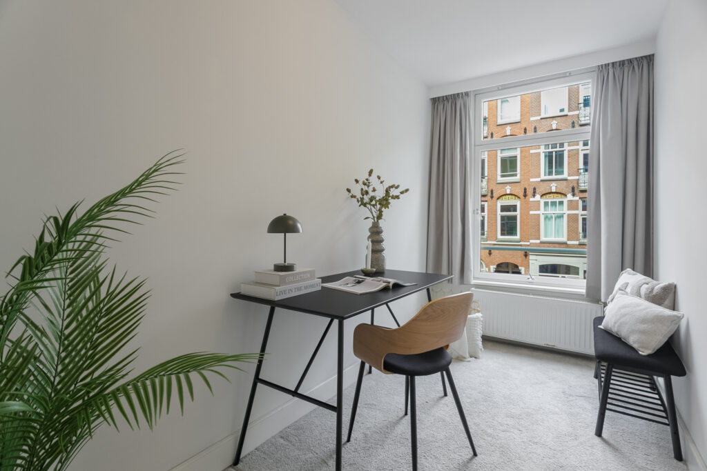 Minimalist home office with large window view.