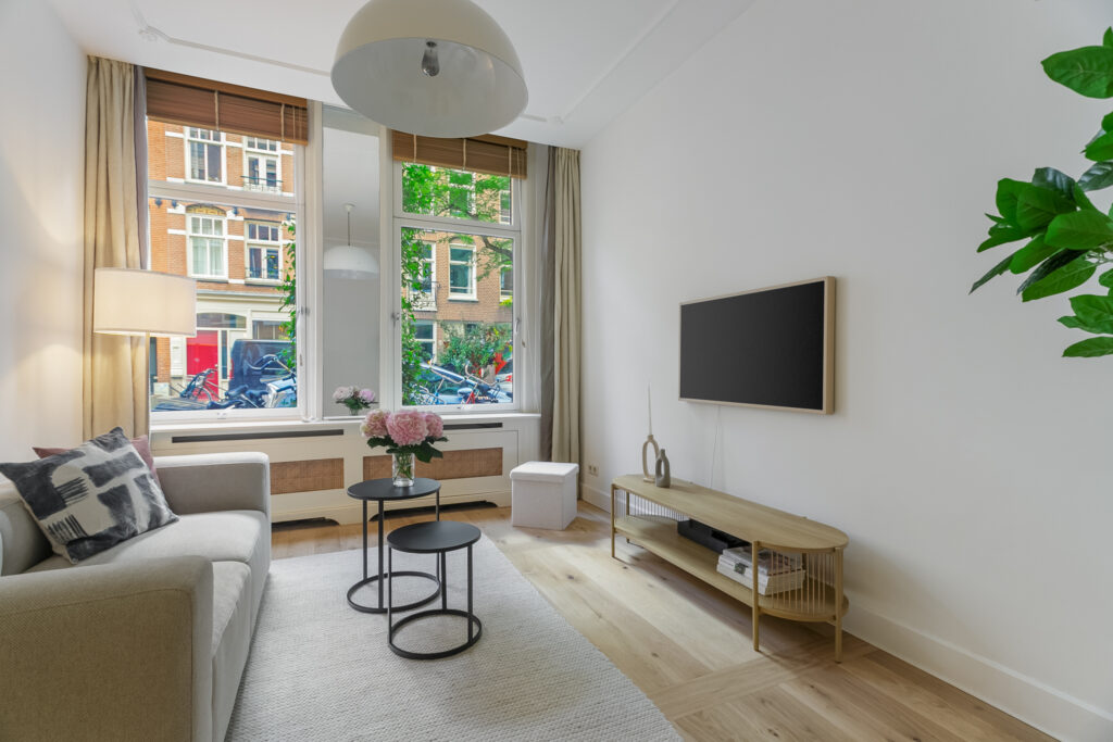 Modern living room with large windows and decor.
