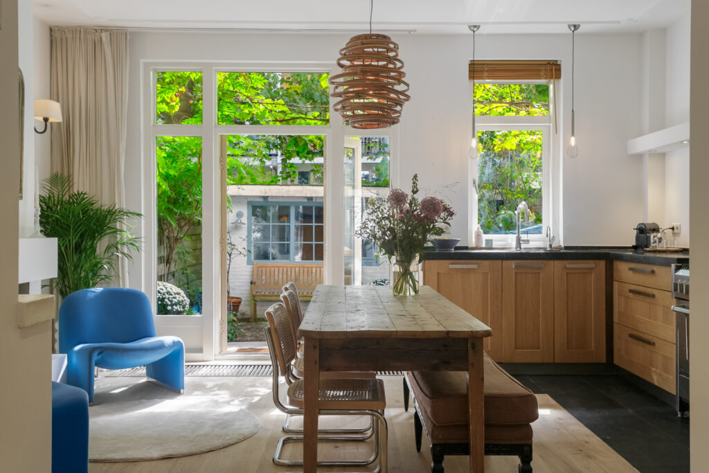 Bright kitchen with wooden table and garden view.