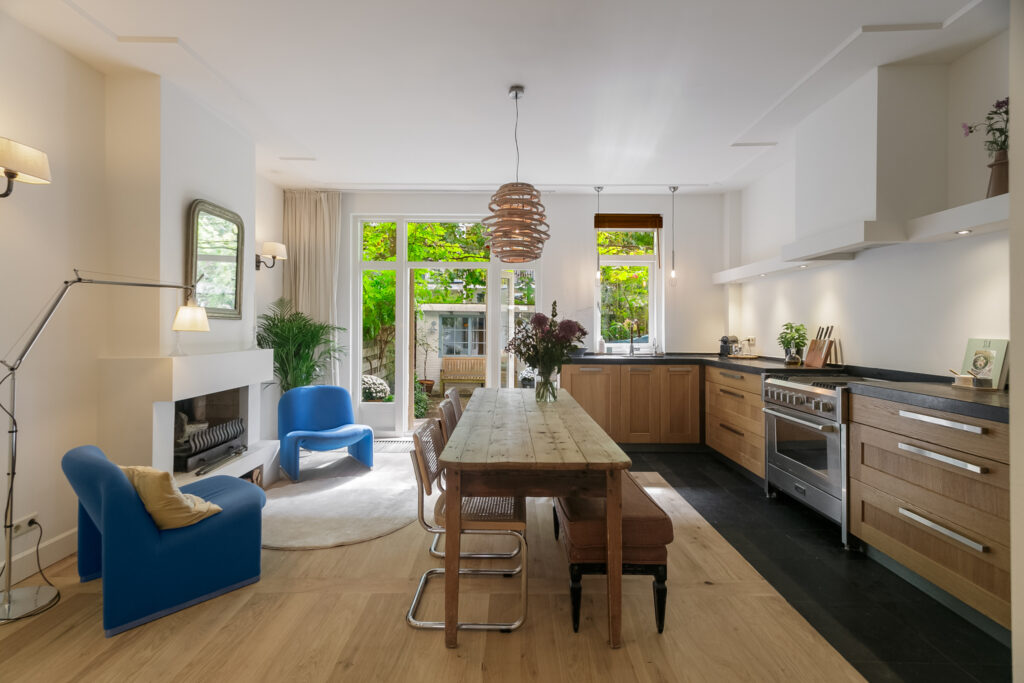Modern kitchen with wooden furniture and garden view.
