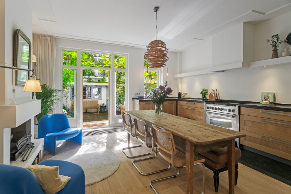 Modern kitchen with wooden table and garden view.