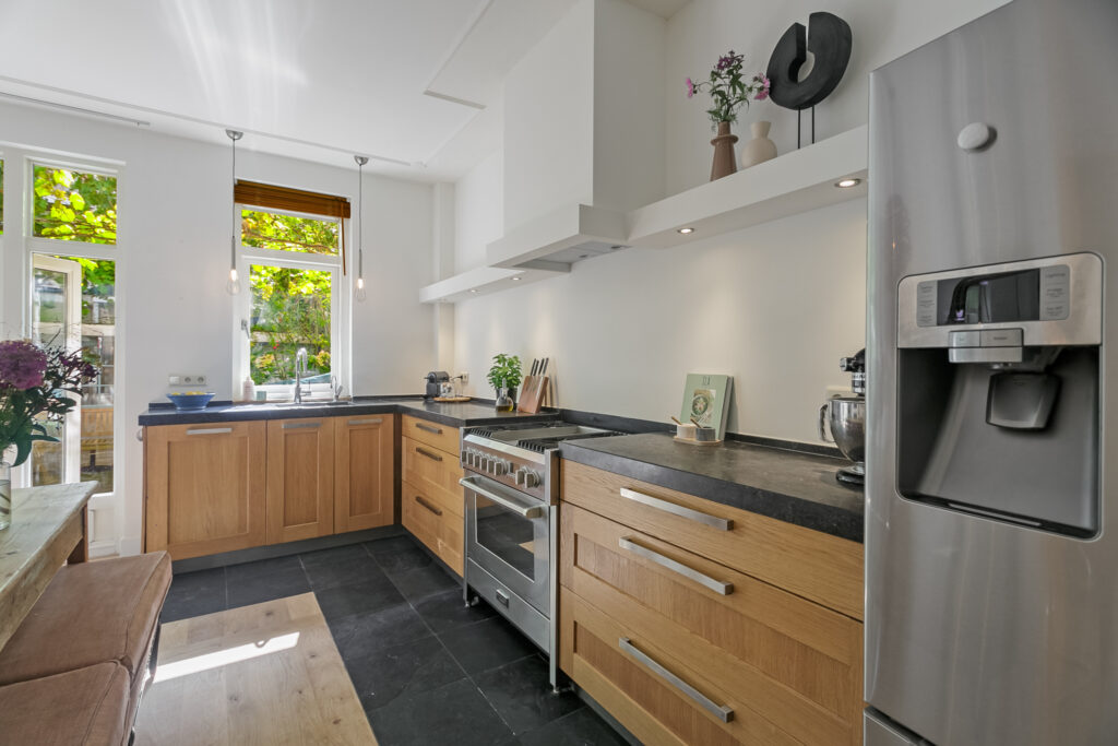 Modern kitchen with wooden cabinets and stainless appliances.