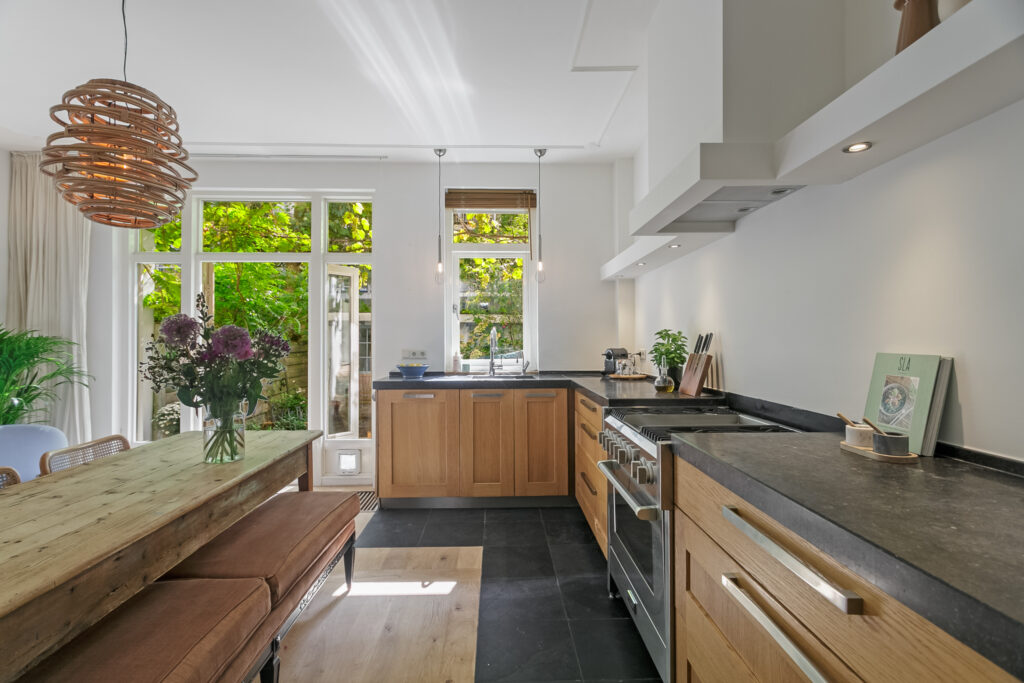 Modern kitchen with wooden cabinets and natural light.