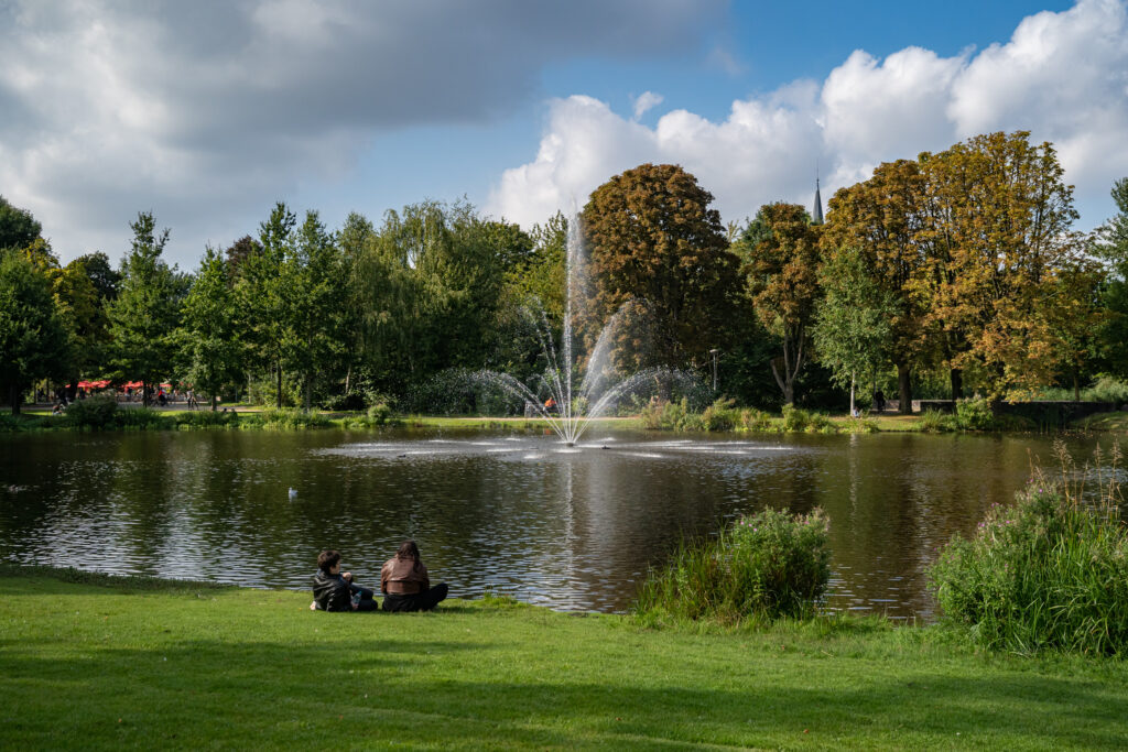 Park with fountain and people relaxing nearby