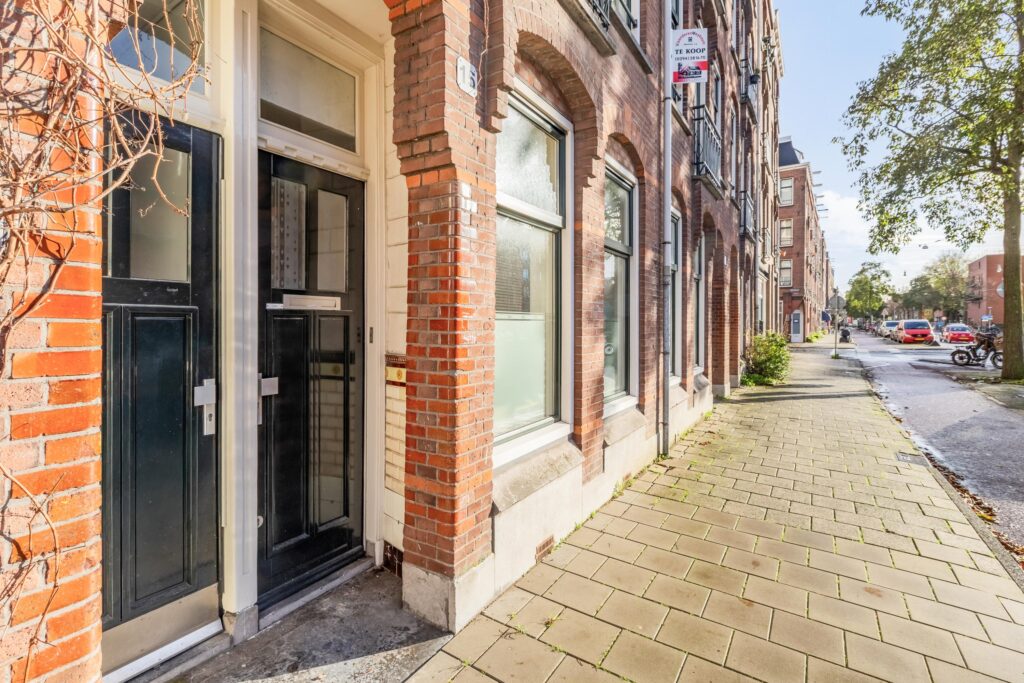Sunny street with brick buildings and sidewalk