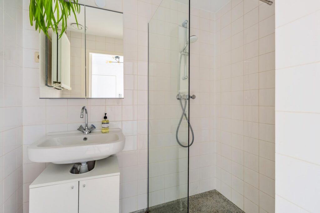 Modern bathroom with sink and shower area.