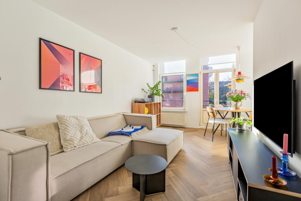 Bright modern living room with beige sofa.