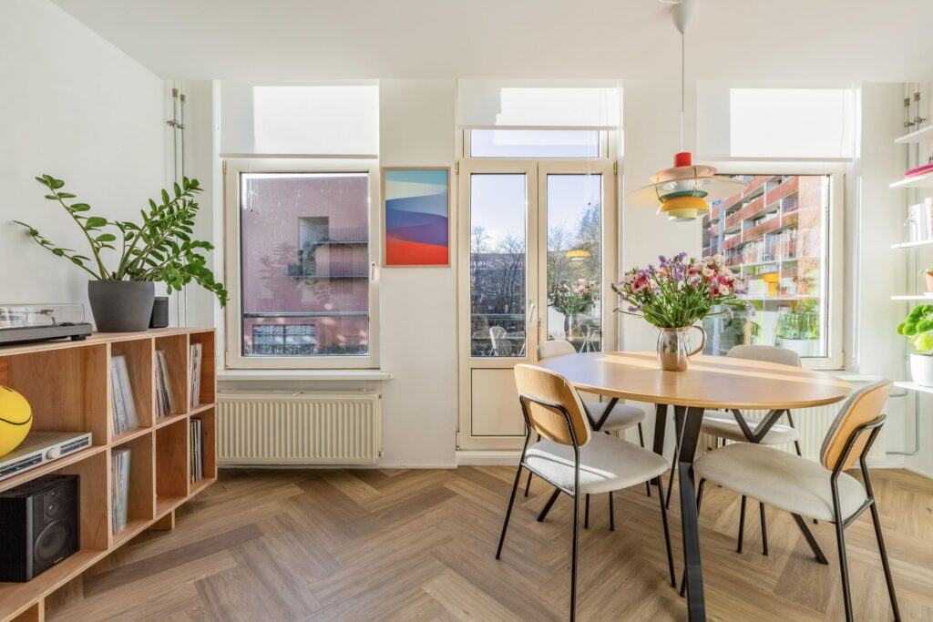 Bright dining room with plants and large windows