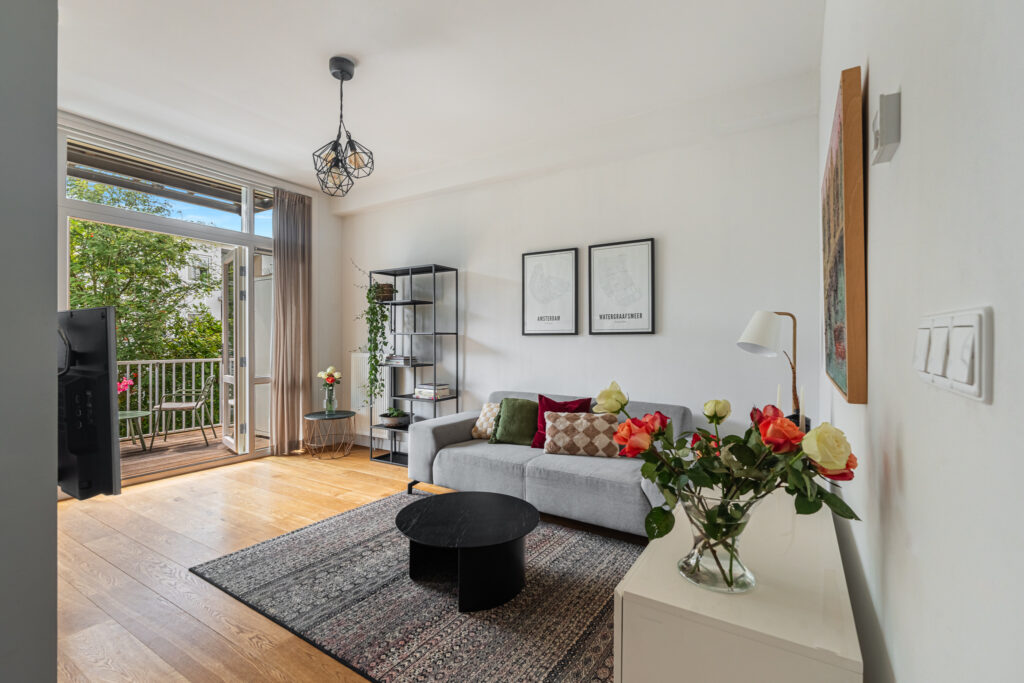 Modern living room with balcony and plants.