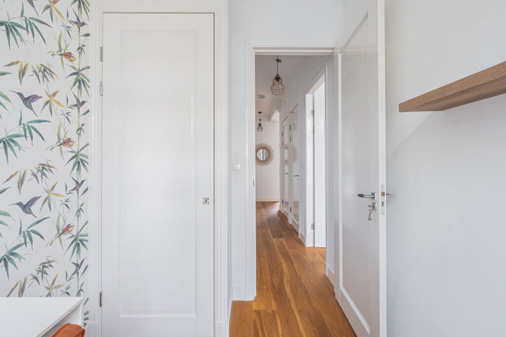 Hallway with wooden floor and decorative wallpaper