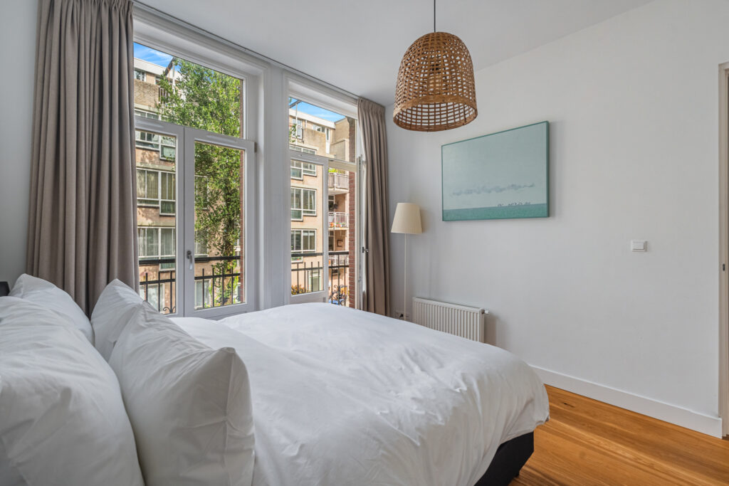Cozy bedroom with large windows and minimalist decor