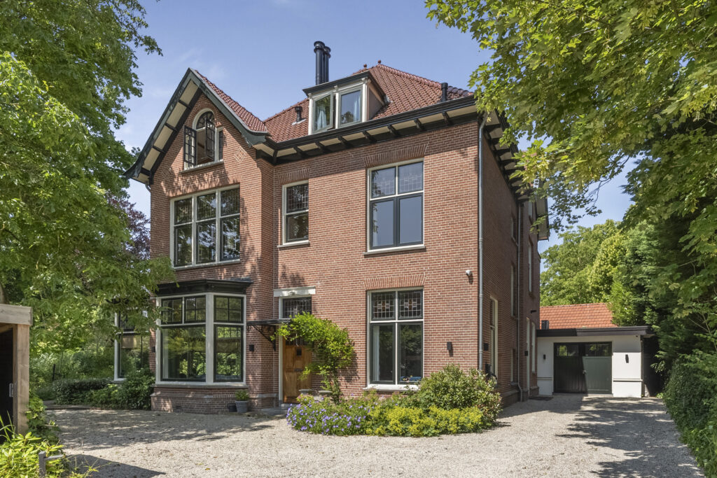 Large brick house with garden and garage