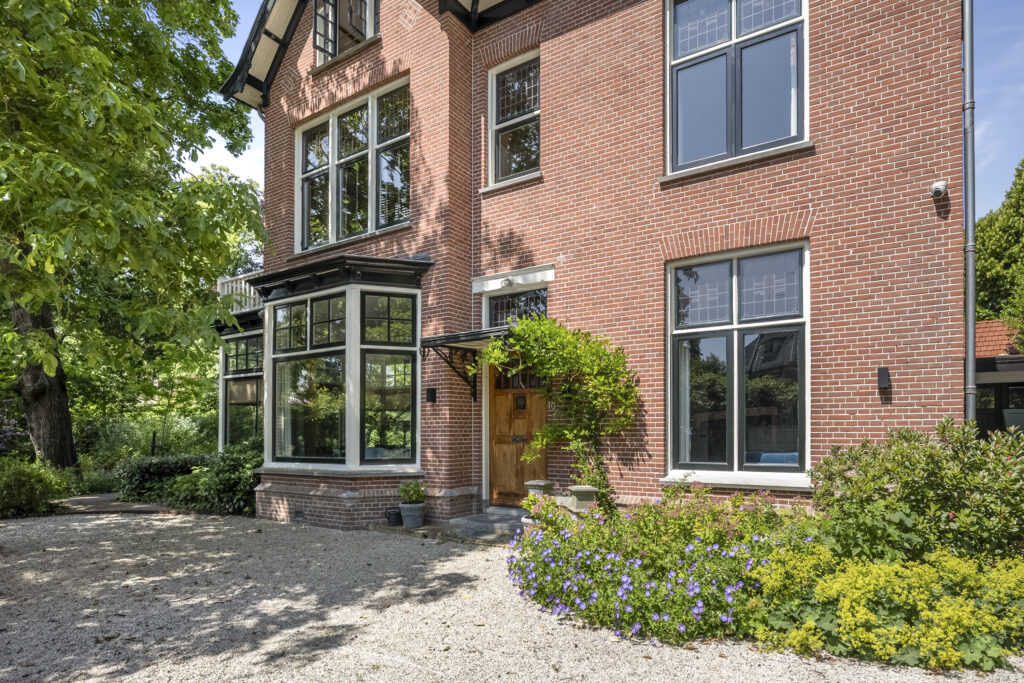 Brick house with large windows and garden