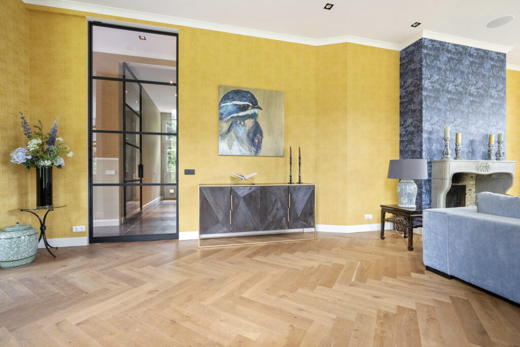 Modern living room with yellow walls and fireplace.