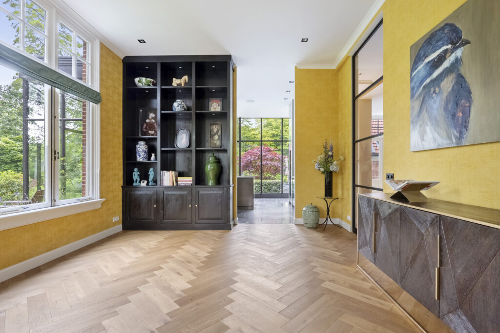 Modern living room with yellow walls and wooden flooring