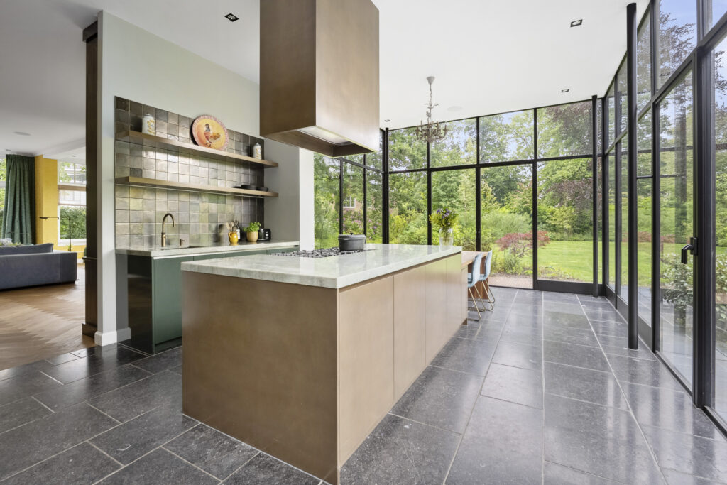 Spacious modern kitchen with garden view windows.