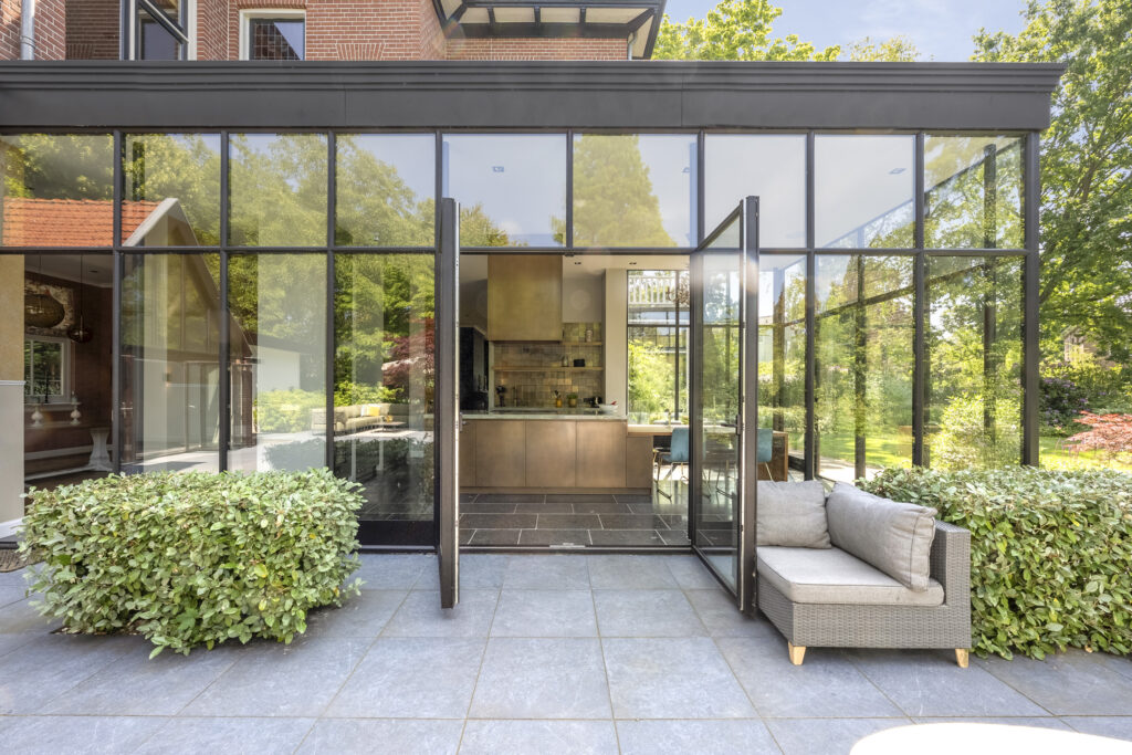 Modern glass-walled extension with open garden view