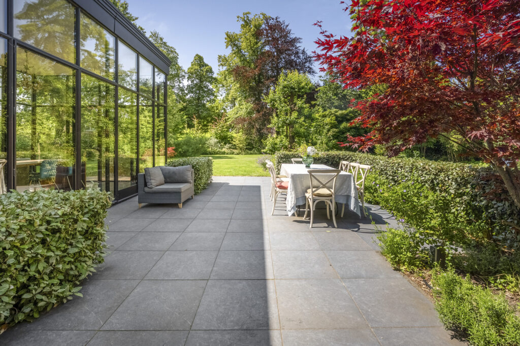 Modern patio with garden view and dining area