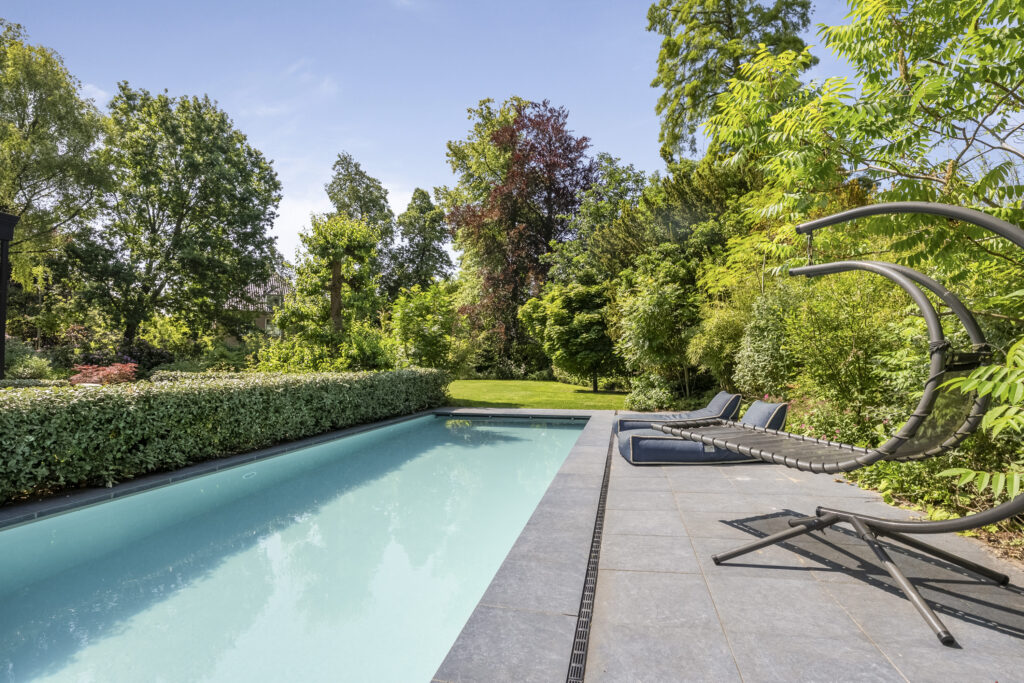 Sunny garden with pool and lounge chairs