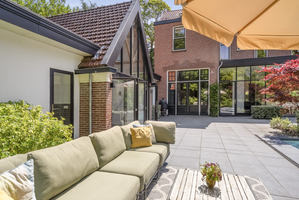 Modern patio with outdoor seating and garden view.