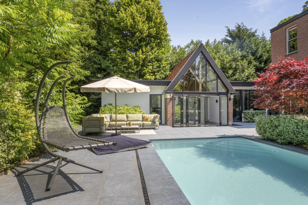 Modern house with pool and landscaped garden.