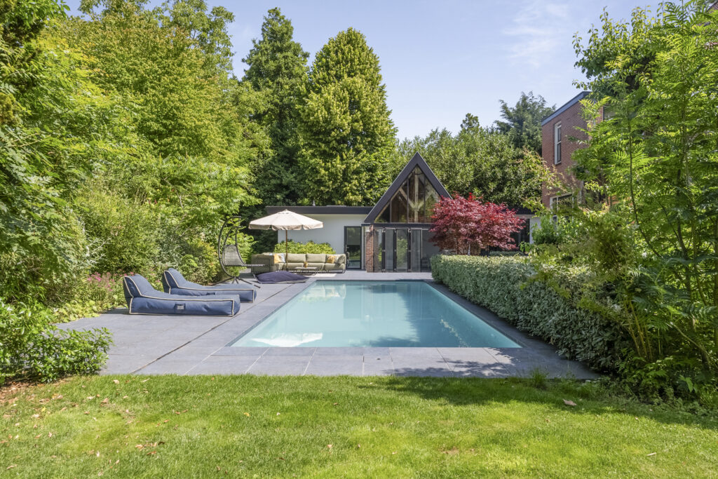 Modern backyard with pool and garden view.