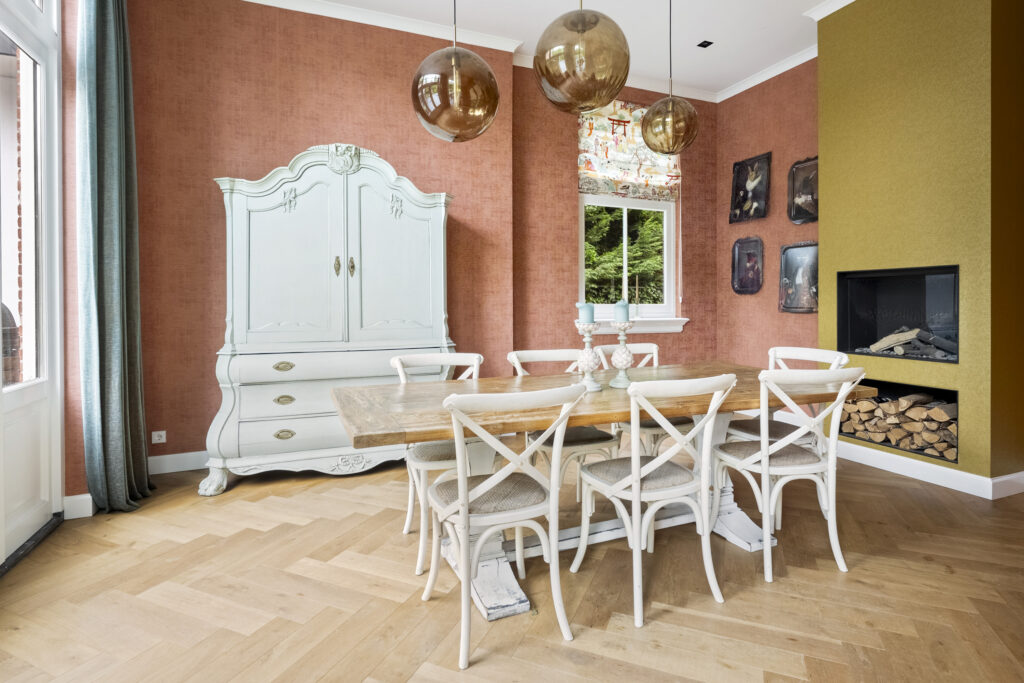 Modern dining room with wooden table and vintage cabinet.