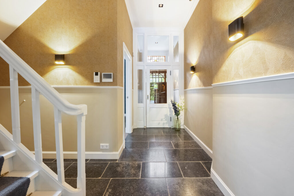 Elegant hallway with staircase and glass door