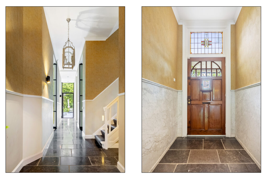 Elegant hallway entrance with wooden door and stairs.